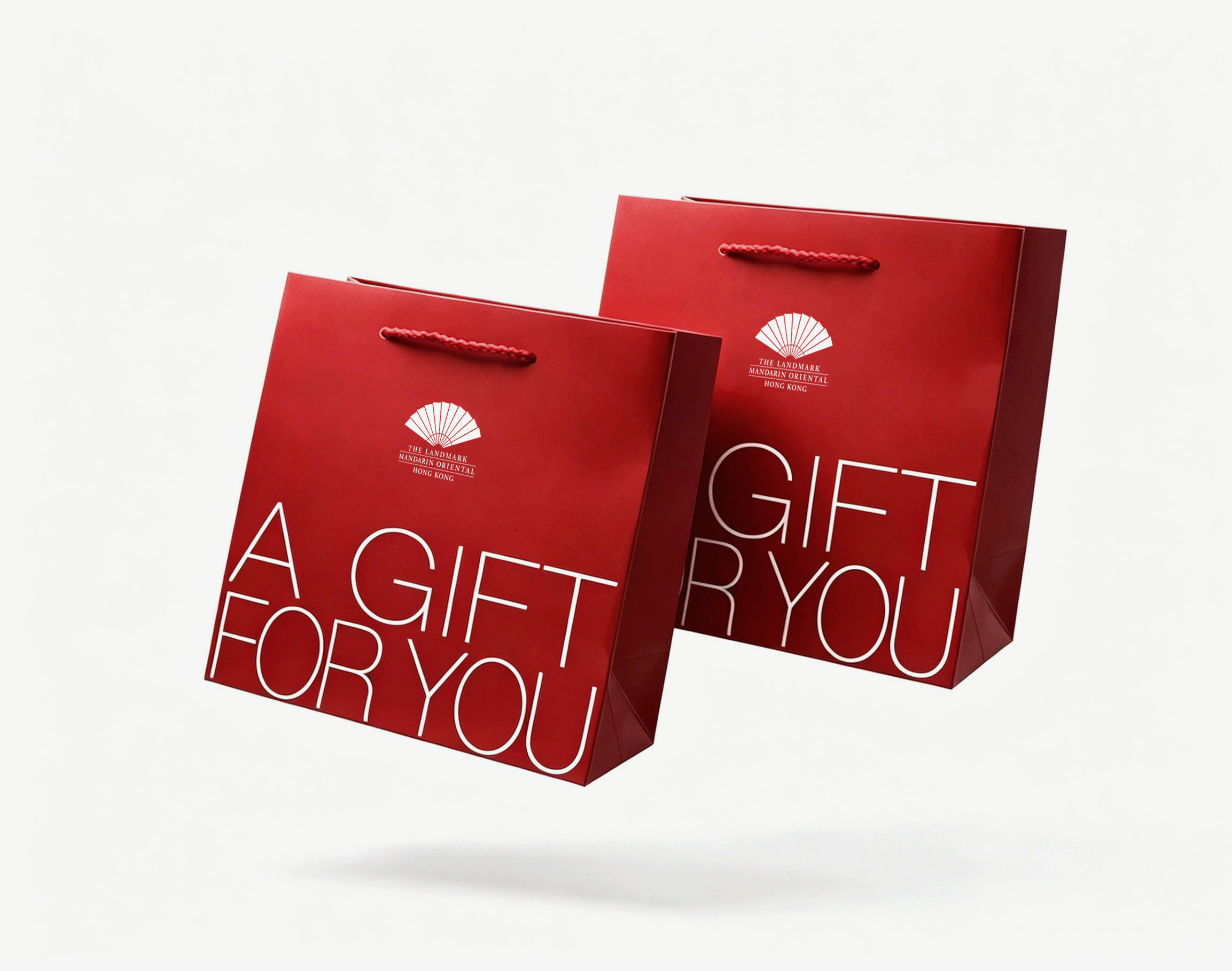 Two red gift bags with a logo on them.

Description generated by AI
